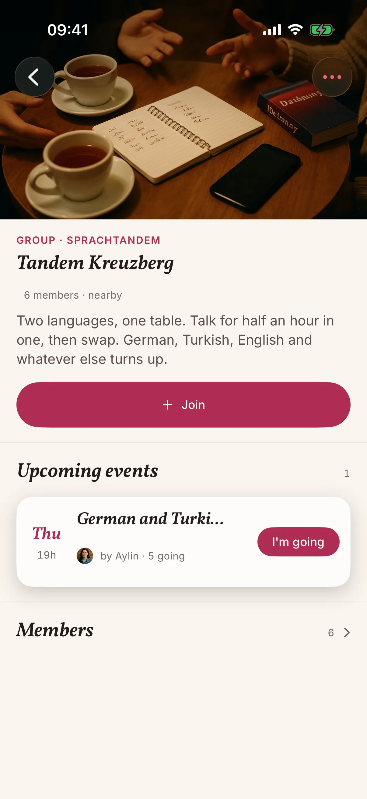 A group in the snakken app: Tandem Kreuzberg with a photo of a café table set for a language evening, six members, one upcoming evening and a button to join.